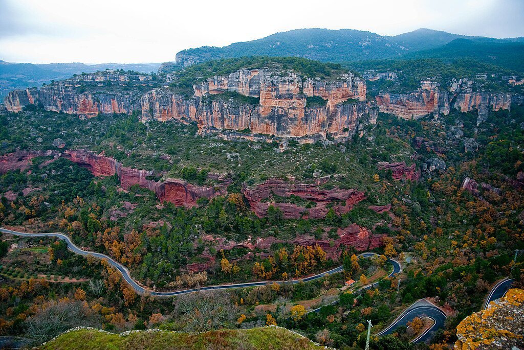 A canyon road winding beneath the cliffs of Siurana, Spain