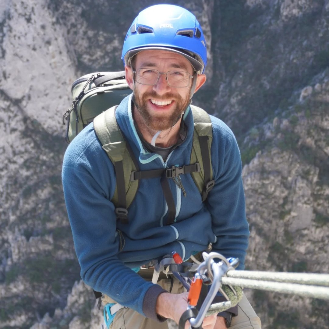 Taylor mid-rappel above a limestone gorge